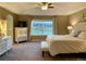 Main bedroom with a king-size bed, dresser, and picturesque window view at 2393 Fairway Wood Cir, Castle Rock, CO 80109