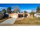 Single story house with attached garage and landscaping at 11343 W 60Th Pl, Arvada, CO 80004