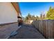 Side yard with gravel and a wooden fence at 11343 W 60Th Pl, Arvada, CO 80004