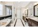 Elegant bathroom with marble finishes and double vanities at 711 Hiddenbrook Ct, Highlands Ranch, CO 80126