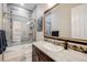 Elegant bathroom with granite vanity, mosaic tile, and shower/tub combo at 711 Hiddenbrook Ct, Highlands Ranch, CO 80126