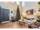 Living room with high ceilings, wood floors, a decorated Christmas tree, and stylish furniture at 1162 S Chester Ct, Denver, CO 80247