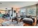 Living room showcasing hardwood floors, open layout, and view towards kitchen at 1162 S Chester Ct, Denver, CO 80247