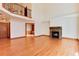 Bright living room with hardwood floors and a cozy fireplace at 6731 S Newcombe Way, Littleton, CO 80127