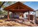 Covered patio with wooden beams and stone wall at 6731 S Newcombe Way, Littleton, CO 80127