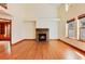 Living room with hardwood floors, fireplace and view of library at 6731 S Newcombe Way, Littleton, CO 80127