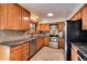 Updated kitchen featuring stainless steel appliances and wood cabinets at 6731 S Newcombe Way, Littleton, CO 80127