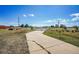 Concrete driveway leading to a home with white gates at 9300 Wadsworth Blvd, Broomfield, CO 80021