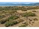 Aerial view of property with horseback riders, showcasing surrounding landscape and mountain views at 4880 Tall Horse Trl, Sedalia, CO 80135