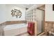 Relaxing bathroom with a soaking tub and glass block feature at 3225 W Scott Pl, Denver, CO 80211