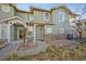 Green two-story townhome with attached garage and landscaping at 10411 Truckee St # A, Commerce City, CO 80022