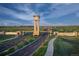 Entrance to The Aurora Highlands community with a clock tower and landscaping at 23931 E 40Th Ave, Aurora, CO 80019