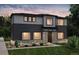 Two-story home with gray and dark siding, stone accents, and landscaping at 23931 E 40Th Ave, Aurora, CO 80019