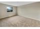 Well-lit bedroom featuring neutral carpet and walls at 1822 S Joplin St, Aurora, CO 80017