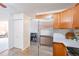 Kitchen with stainless steel appliances and wood cabinets at 660 S Alton Way # 7A, Denver, CO 80247