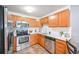 Modern kitchen with stainless steel appliances and white countertops at 660 S Alton Way # 7A, Denver, CO 80247