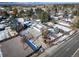 An aerial view showcasing a house with a large yard, detached garage, and surrounding neighborhood at 6101 S University Blvd, Centennial, CO 80121