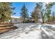 House backyard view with deck and trees at 6101 S University Blvd, Centennial, CO 80121