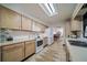 Bright kitchen features light wood cabinets, modern appliances, and view to dining area at 6101 S University Blvd, Centennial, CO 80121