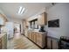 Bright kitchen with wood cabinets, and view into the dining room at 6101 S University Blvd, Centennial, CO 80121