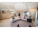 Open concept living room with sectional sofa, large windows, and high ceilings at 6101 S University Blvd, Centennial, CO 80121