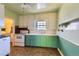 Small kitchen with green cabinets and vintage appliances at 2648 S Pennsylvania St, Denver, CO 80210