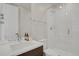 Modern bathroom with a walk-in shower, single sink vanity, and updated fixtures at 30 S Oneida St, Denver, CO 80230