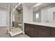 Elegant bathroom with a large glass shower and dark brown double vanity at 30 S Oneida St, Denver, CO 80230