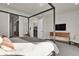 Spacious main bedroom with a king-size bed, en-suite bathroom access, and TV at 30 S Oneida St, Denver, CO 80230