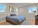 Bright bedroom with large windows, a queen-size bed, and hardwood floors at 30 S Oneida St, Denver, CO 80230