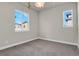 Well-lit bedroom with carpet flooring and large windows at 30 S Oneida St, Denver, CO 80230