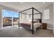 Main bedroom with a canopy bed, large windows, and access to a balcony at 30 S Oneida St, Denver, CO 80230