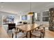 Open concept dining area with a large wooden table and access to the patio at 30 S Oneida St, Denver, CO 80230