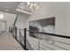 Spacious hallway with a modern chandelier and large artwork at 30 S Oneida St, Denver, CO 80230