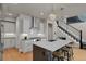 Modern kitchen with white cabinets, stainless steel appliances, and an island at 30 S Oneida St, Denver, CO 80230