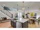 Modern open concept kitchen with island and stainless steel appliances at 30 S Oneida St, Denver, CO 80230