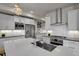 Modern kitchen with white cabinets, herringbone backsplash, and large island at 30 S Oneida St, Denver, CO 80230