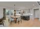 Modern kitchen with white cabinets, island, and stainless steel appliances at 30 S Oneida St, Denver, CO 80230