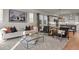 Bright living room with comfy seating, large windows, and a modern glass coffee table at 30 S Oneida St, Denver, CO 80230