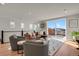 Spacious living room with hardwood floors, large windows, and access to a deck at 30 S Oneida St, Denver, CO 80230