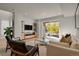 Spacious living room with large windows, comfortable seating, and a glass coffee table at 30 S Oneida St, Denver, CO 80230