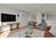 Living area with hardwood floors, comfortable seating, and a large flat-screen TV at 30 S Oneida St, Denver, CO 80230
