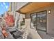 Covered patio with seating area and view of the living room at 30 S Oneida St, Denver, CO 80230
