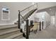 Modern staircase with metal railings and a small workspace on the landing at 30 S Oneida St, Denver, CO 80230