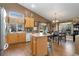 Well-appointed kitchen with ample counter space, wooden cabinetry, and an island with seating at 5715 E 130Th Way, Thornton, CO 80602