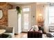 Bright living room with French doors leading to a patio and an exposed brick wall at 3232 Arapahoe St, Denver, CO 80205