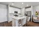 Modern kitchen with white cabinets, island, and stainless steel appliances at 13741 Via Varra, Broomfield, CO 80020