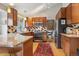 Spacious kitchen with granite countertops, wooden cabinets, and modern appliances at 4022 S Quebec St, Denver, CO 80237