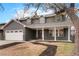 Two-story house with gray siding, white garage door, and landscaped yard at 4951 S Arbutus St, Morrison, CO 80465