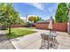 Private backyard with a patio, storage shed, and ample green space at 1454 Rosemary St, Denver, CO 80220